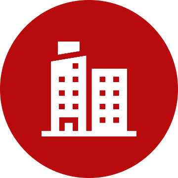 White building icon on red circle background.